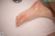 A close up of a woman's foot in a sink.